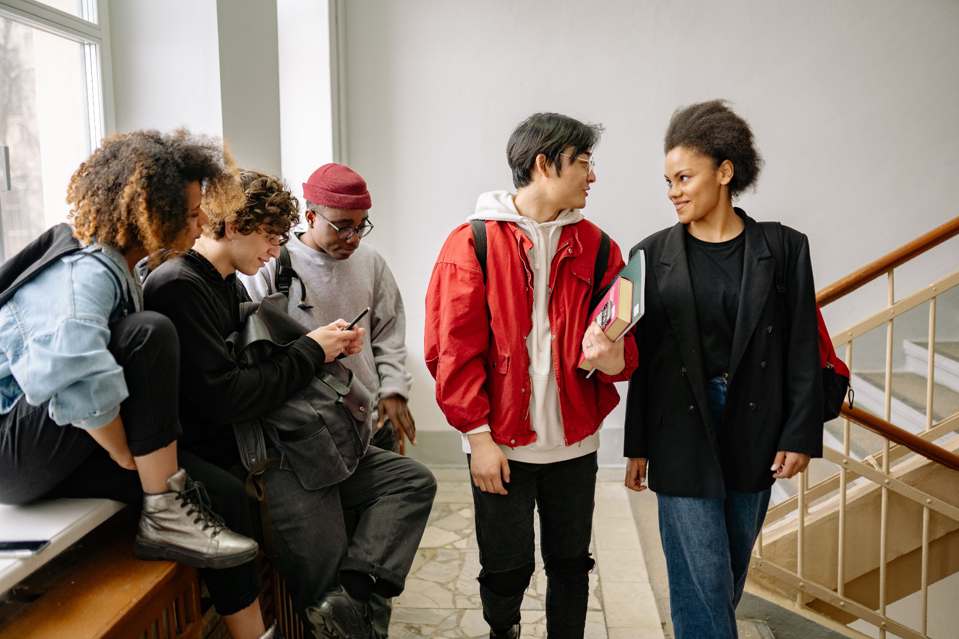 Students chatting on a staircase between classes