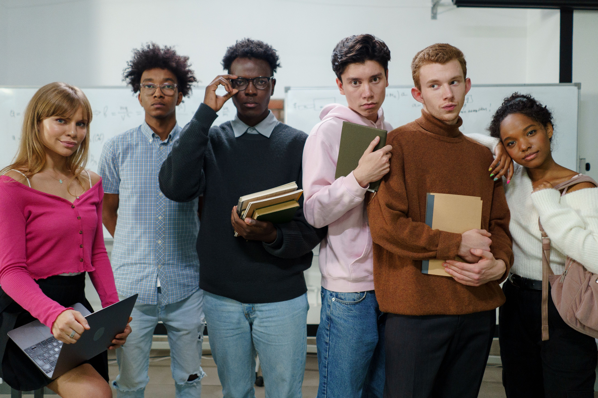 Diverse group of students posing together in a classroom