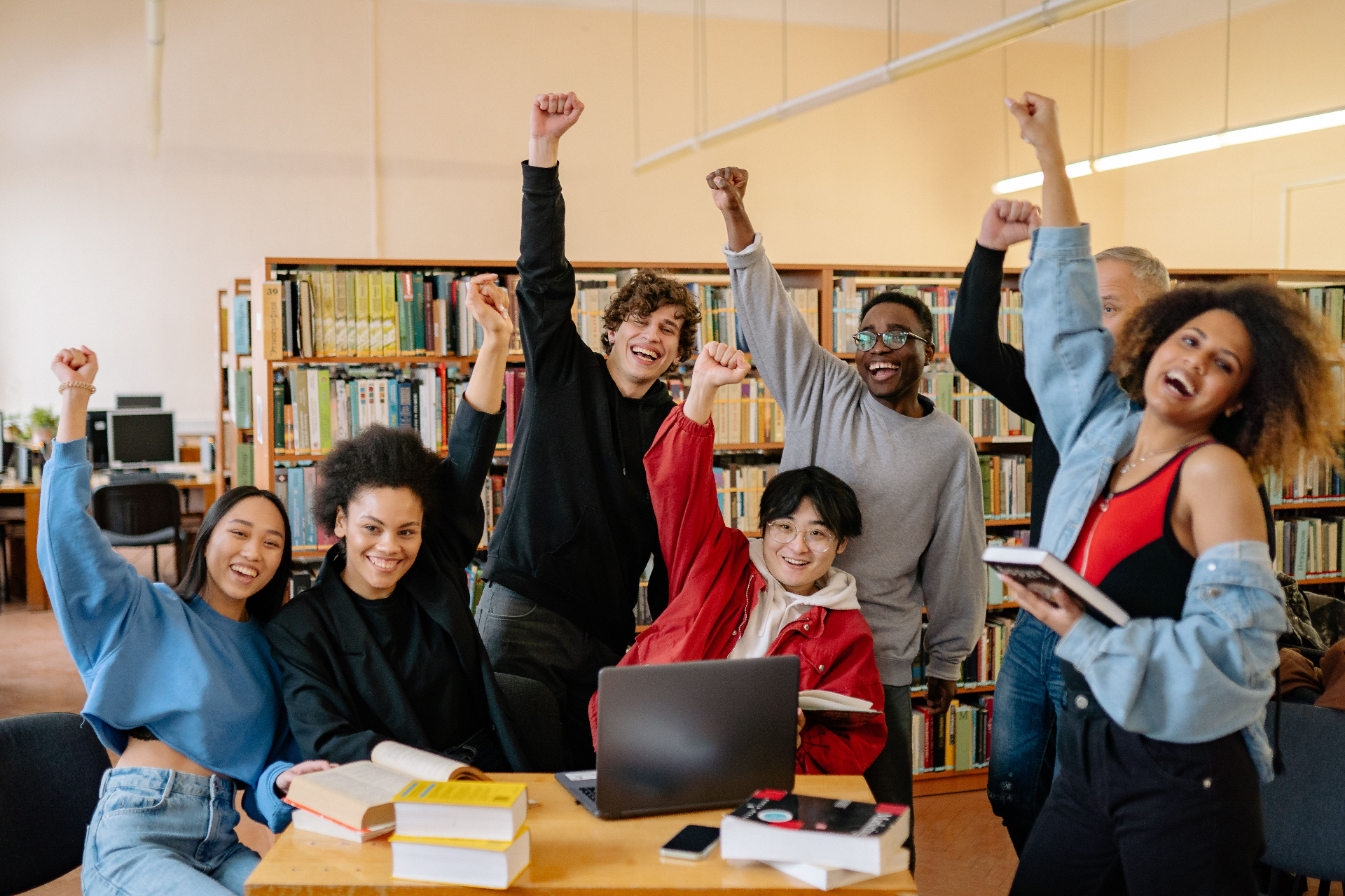 Diverse students celebrating scholarship success on campus