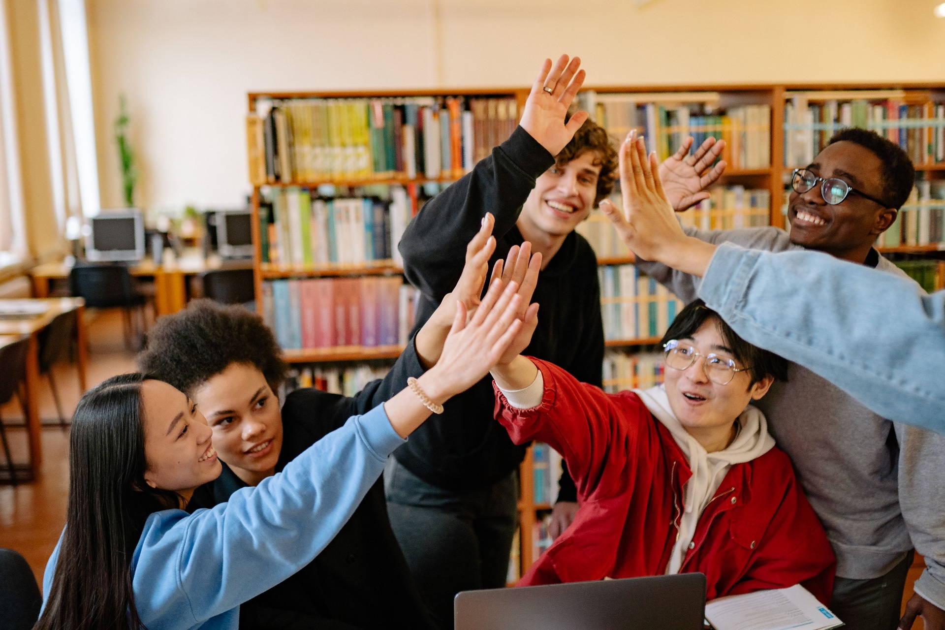 Students collaborating and smiling in a university library